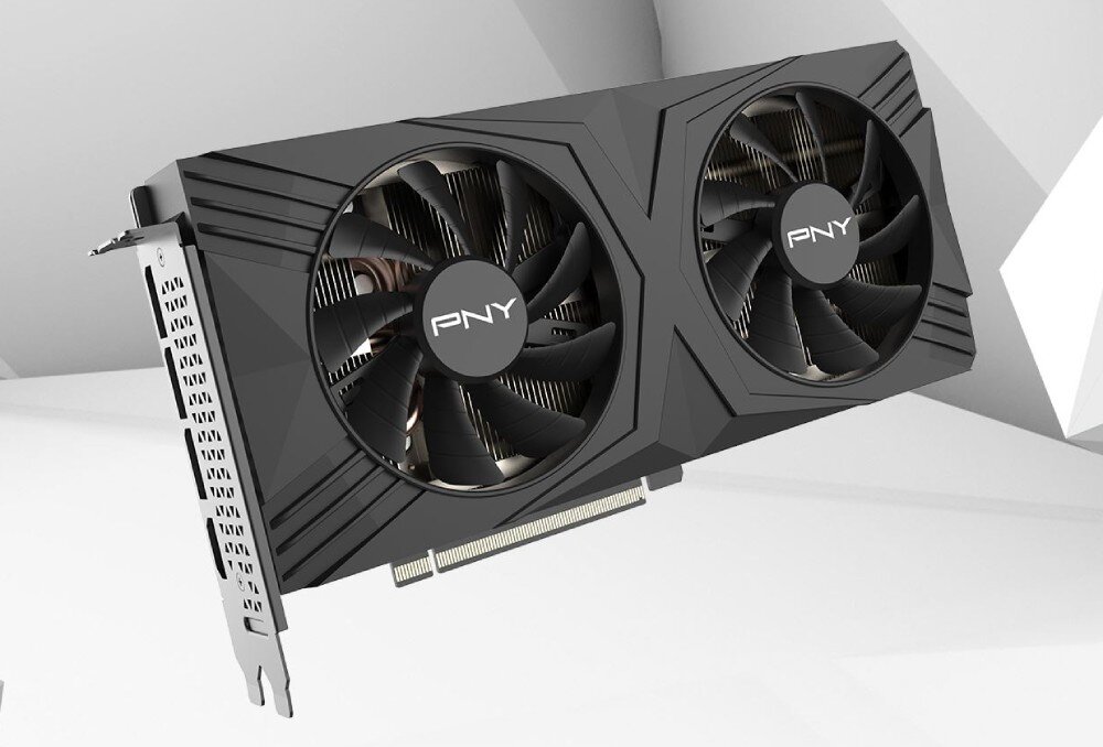 Komputer MAD DOG DIAXID605-A15WR32WH Karta graficzna z dwoma dużymi wentylatorami, widoczna pod lekkim kątem. Obudowa w ciemnym kolorze z geometrycznymi liniami, na środku każdego wentylatora znajduje się logo 'PNY', karta graficzna, architektura, technologie, wentylatory