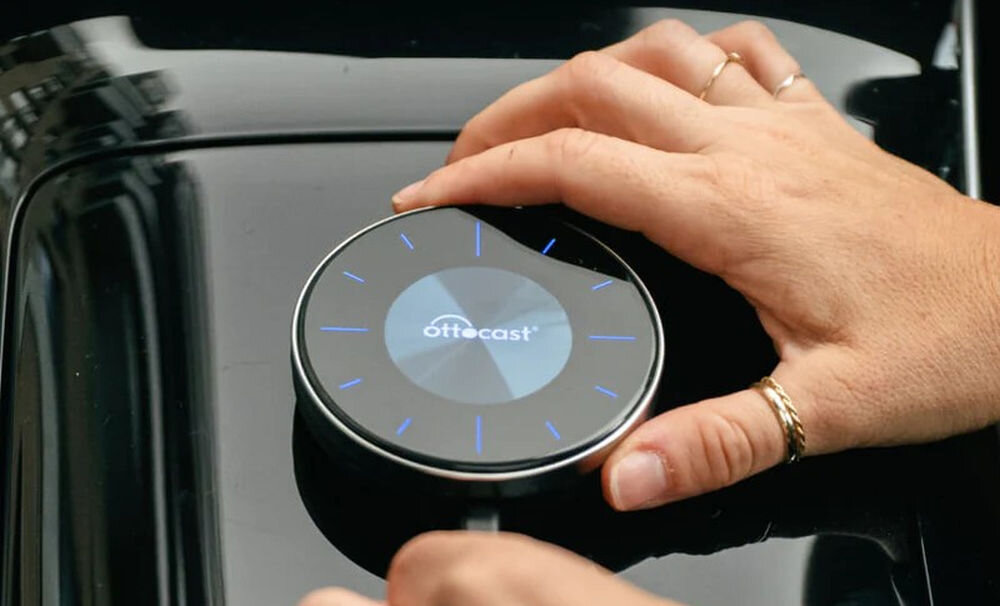 Adapter OTTOCAST PCS46 OttoAibox P3 CarPlay Android Auto instalacja plug and play aktualizacje FOTA oświetlenie ambientowe, osoba podłączjąca adapter pod kabel USB