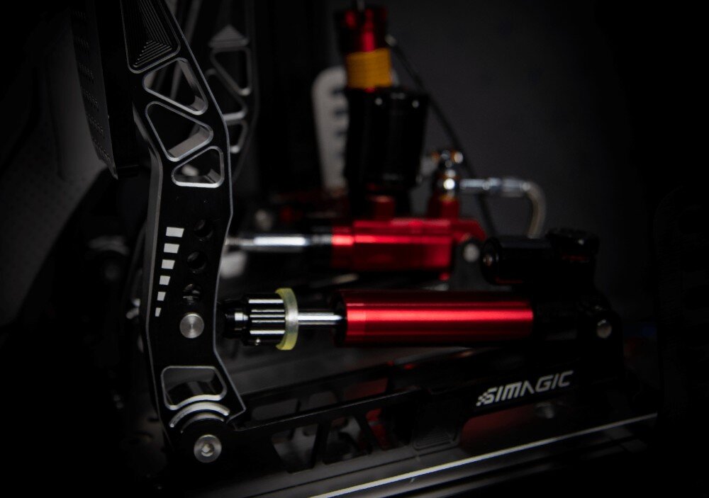 System hydrauliczny z trzema pedałami SIMAGIC S309 Detal ramienia pedału z bliska w ciemnym otoczeniu, widoczny poziomy siłownik oraz konstrukcja z wycięciami