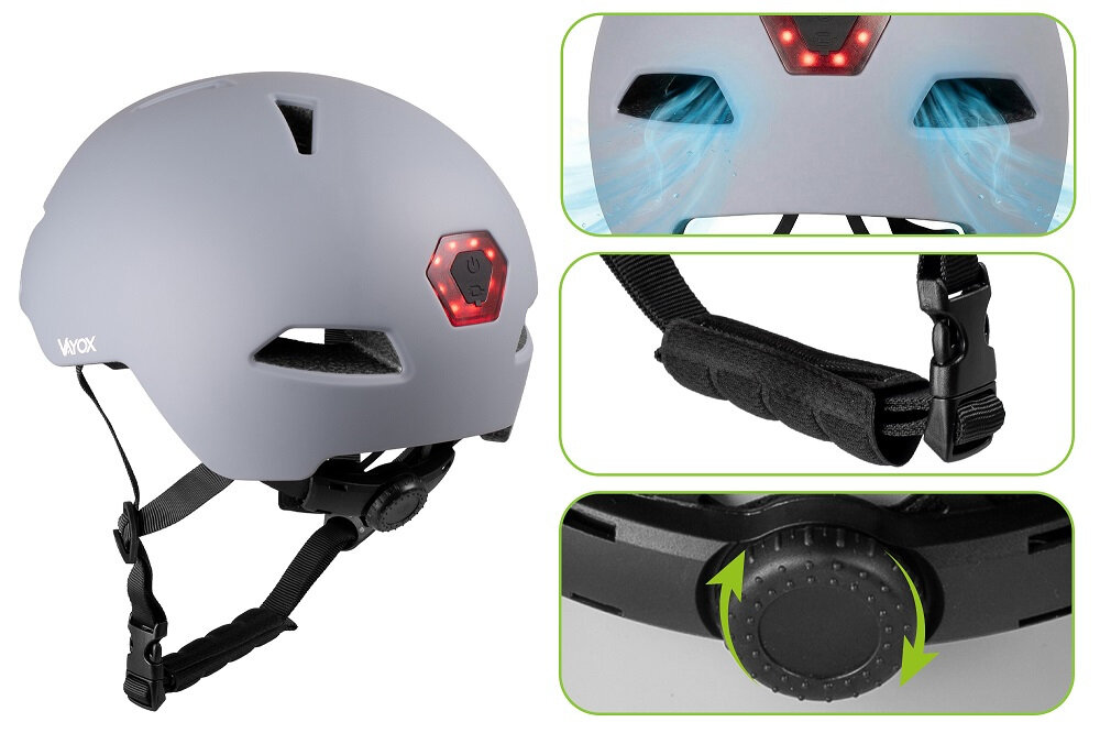Szary kask rowerowy z czerwonym światłem z tyłu, posiada regulowany pasek i pokrętło do dopasowania rozmiaru. Widoczne logo \'VAYOX\'.