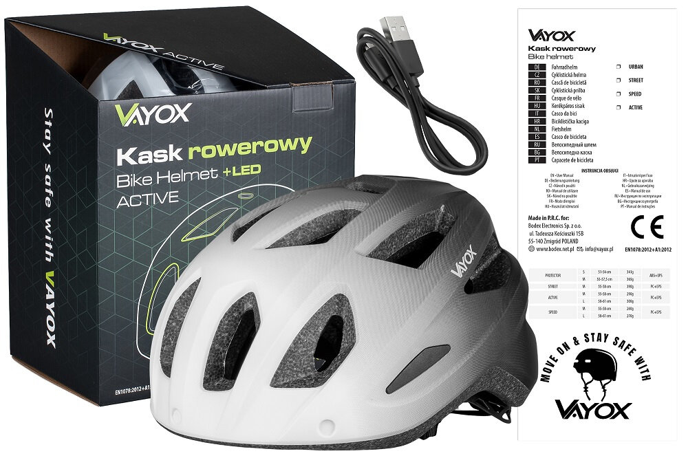 Na obrazie znajduje się biało-czarny kask rowerowy z napisem \'VAYOX\' oraz pudełko z tekstem \'Kask rowerowy Bike Helmet +LED ACTIVE\'. Obok kasku leży kabel USB, a po prawej stronie widoczna jest instrukcja z logo VAYOX i napisem \'MOVE ON & STAY SAFE WITH\'.
