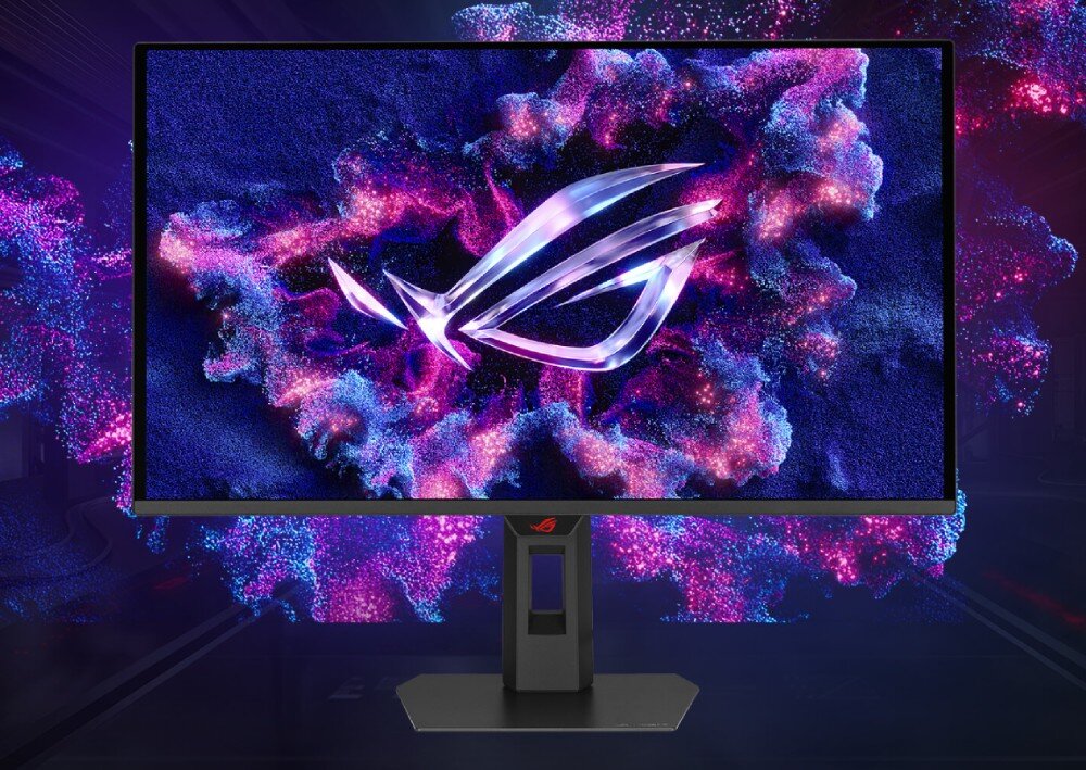 Monitor ASUS ROG Strix XG27AQDNG Monitor komputerowy pokazany od przodu wyświetla abstrakcyjną grafikę w odcieniach fioletu i niebieskiego z jasnym logotypem w kształcie oka na środku, a w tle widać rozmyte punkty świetlne, opis