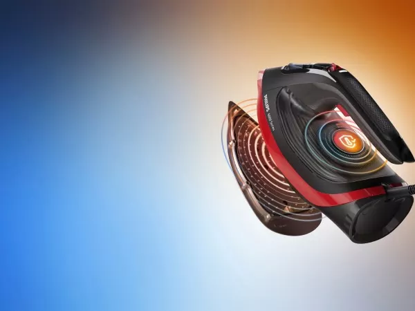 Obraz przedstawia żelazko z widocznym logo \'Philips 6000 Series\' na tle gradientu przechodzącego od niebieskiego do pomarańczowego. Żelazko ma czarno-czerwoną kolorystykę z widocznymi elementami technologicznymi na spodzie.
