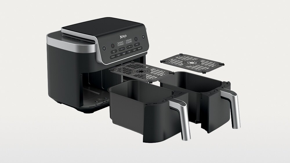 Na obrazie widoczna jest czarna frytkownica beztłuszczowa z podwójnym koszem i panelem sterowania z przyciskami. Na panelu znajduje się logo \'NINJA\'.