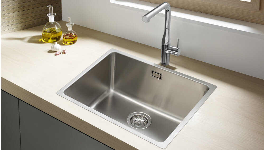 ZLEWOZMYWAK ROCA ROMA 70 A870P10700 STAL NIERDZEWNA Na zdjęciu pokazano stalowy zlewozmywak z zamontowaną baterią o geometrycznej formie. Widoczna powierzchnia stali nierdzewnej podkreśla trwałość i wygląd produktu zlew kuchenny prostokątny głęboka komora komfort pracy