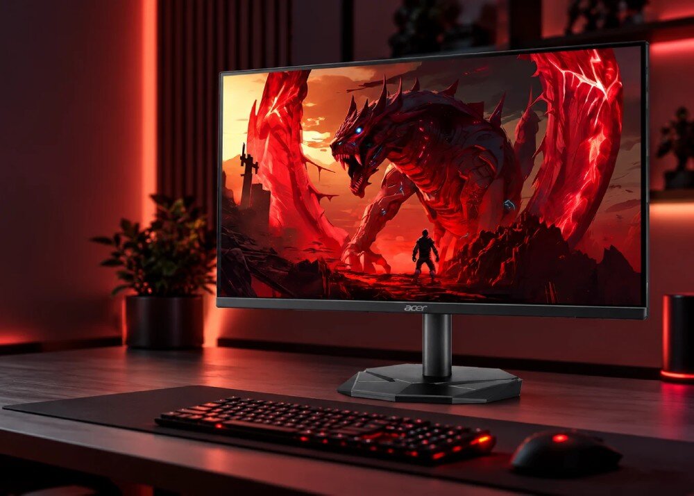 Monitor ACER Nitro KG240YP0bi Monitor stoi na biurku z klawiaturą i myszką, a na jego ekranie wyświetla się grafika z potworem w ruinach