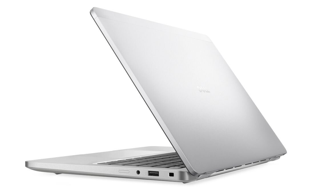 Srebrny laptop z widocznym logo \'Dell\' na pokrywie, otwarty pod kątem, ukazujący klawiaturę i porty boczne.