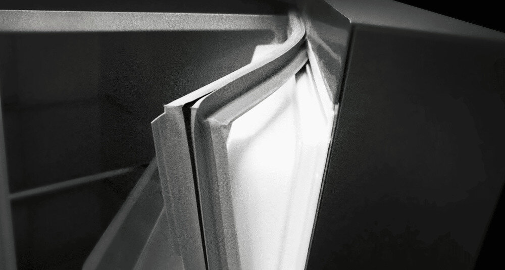 LODÓWKA TCL RF045DWE0 Grafika pokazuje zbliżenie na otwierane drzwi lodówki z wyraźnie widoczną elastyczną uszczelką na krawędzi. Ujęcie podkreśla miejsce styku uszczelki z korpusem urządzenia, sugerując łatwość czyszczenia i szczelne domykanie łatwe czyszczenie uszczelki higiena lodówki brak nieprzyjemnych zapachów prosta pielęgnacja