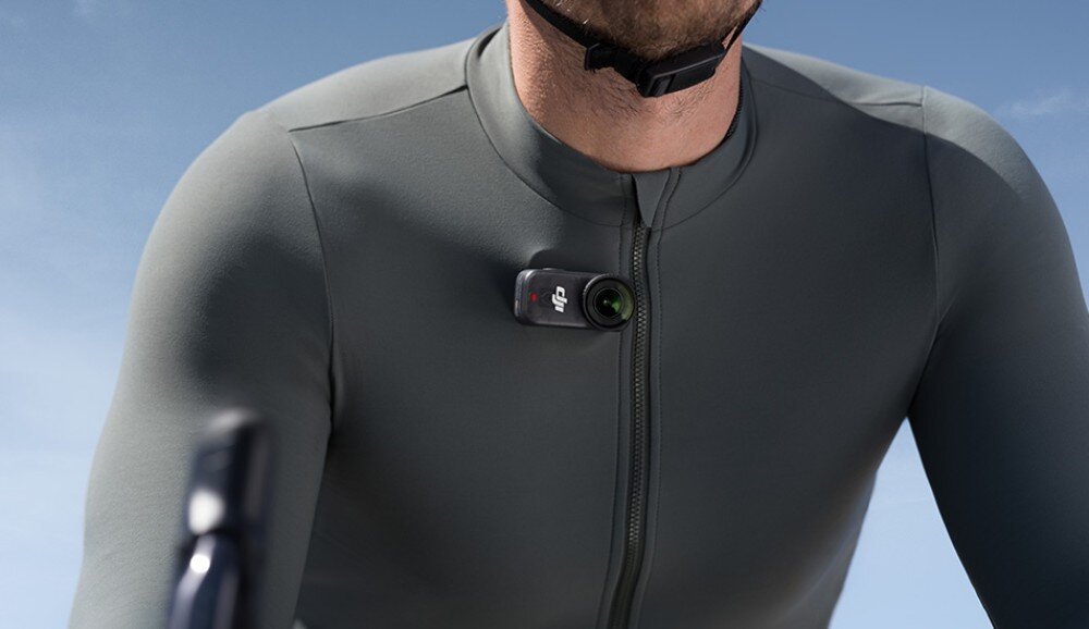 Kamera sportowa DJI Osmo Nano Zbliżenie na kolarza w kasku z kamerą przypiętą do zamka koszulki, bateria, czas działania, ładowanie