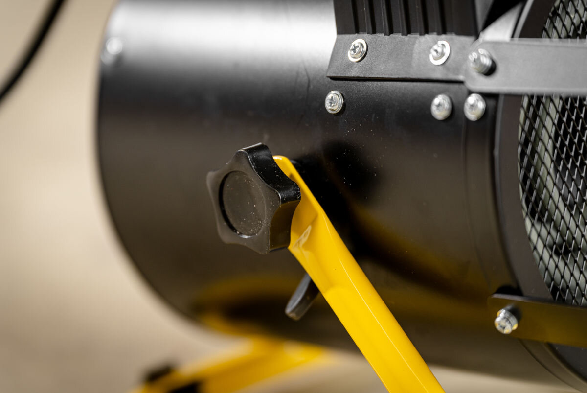 Nagrzewnica elektryczna DEDRA DED9930B, kąt, śruba, precyzja, strefy, Boczne pokrętło regulacji kąta strumienia powietrza, śruba blokująca żółtego stelaża nagrzewnicy.