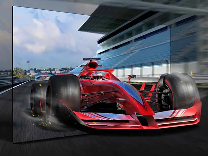 Z ekranu TV wyjeżdża wyraźna wyścigówka, poza tym ekranem obraz się rozmywa.