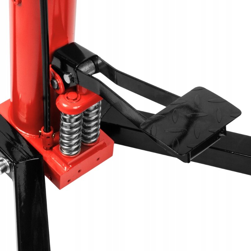 Obraz przedstawia fragment podnośnika z czerwonym cylindrem i czarną platformą nożną. Widoczne są sprężyny oraz metalowe elementy konstrukcji.