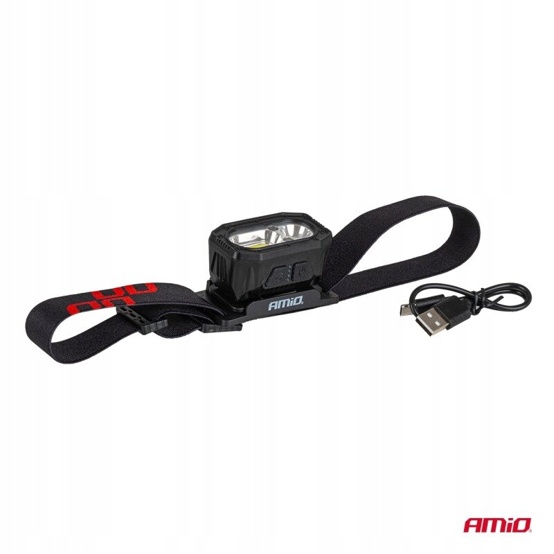 Na obrazie widoczna jest czarna latarka czołowa z elastycznym paskiem i logo \'AMiO\'. Obok znajduje się kabel USB, a w prawym dolnym rogu widnieje logo \'AMiO\'.