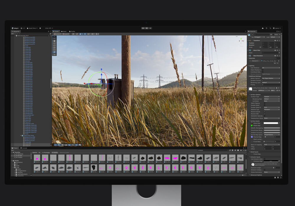 Monitor APPLE Studio Display XDR Interfejs silnika Unity wyświetlający projekt sceny 3D z polnym krajobrazem, liniami wysokiego napięcia i słońcem, wraz z panelami narzędzi projektowych i zasobami.