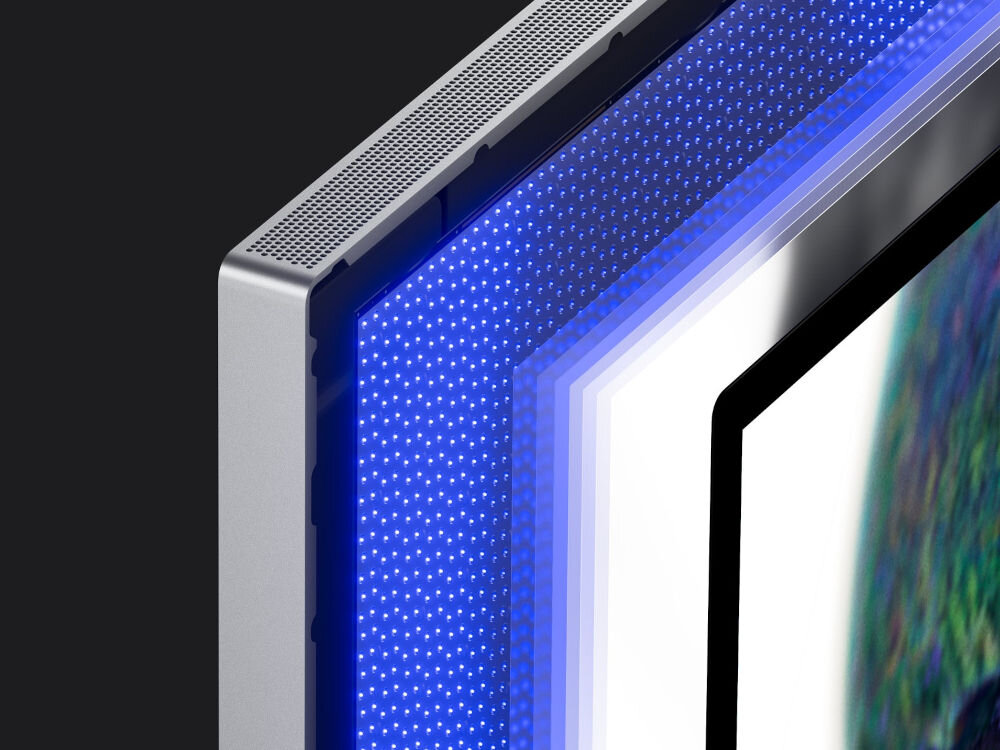 Monitor APPLE Studio Display XDR Zbliżenie na konstrukcję matrycy monitora pokazujące warstwy podświetlenia LED z niebieskimi diodami pod szklanym panelem i aluminiową ramką.