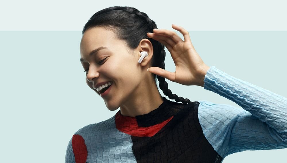 Słuchawki dokanałowe XIAOMI Redmi Buds 6 - kobieta z sluchawkami w uszach