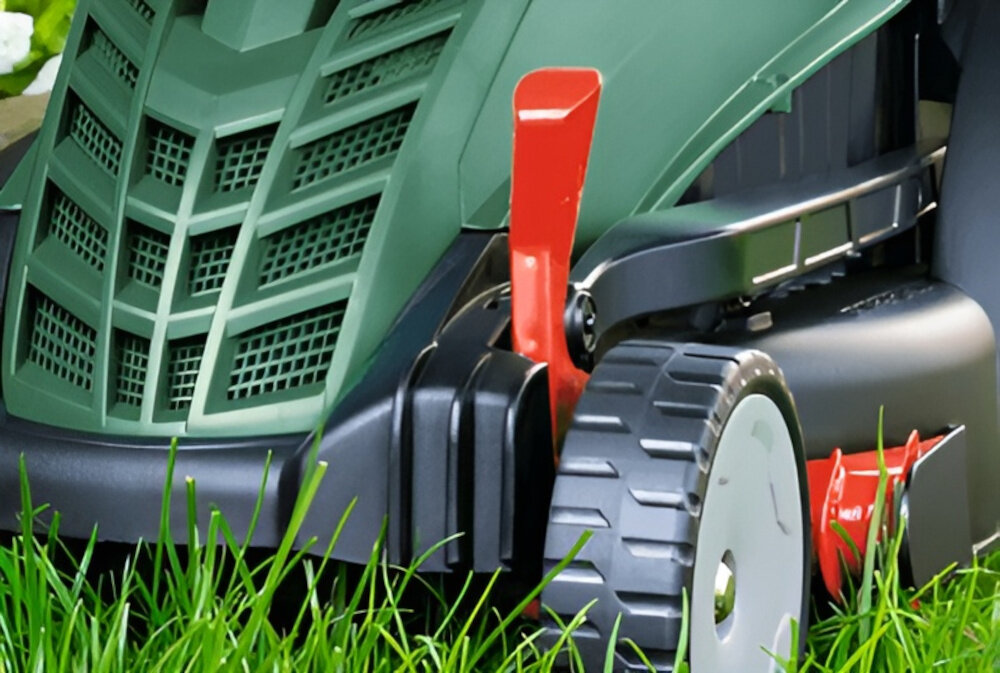 Kosiarka elektryczna BOSCH EasyRotak 32-235 1200 W 320 mm zbliżenie na dźwignię do regulacji 3-stopniowa osiowa regulacja wysokości cięcia w zakresie od 25 do 65 mm dźwignia umieszona tuż obok przedniego koła dopasowanie wysokości trawy do aktualnych potrzeb