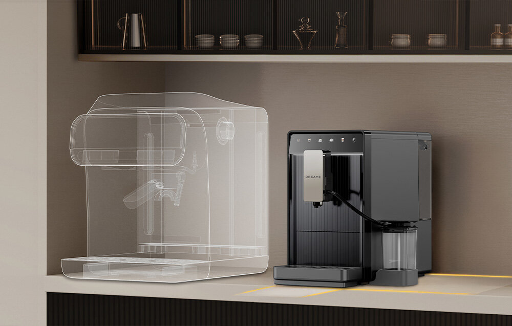 Na blacie kuchennym stoi szary ekspres do kawy z napisem \'DREAME\' na przednim panelu. Obok niego widoczny jest przezroczysty zarys innego ekspresu.