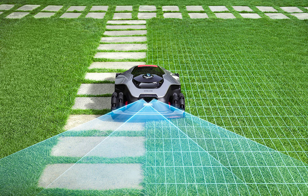 Robot koszący DREAME A3 AWD Pro 5000 trawnik robot ustawiony na trawie chodnik niebieskie pole wyznaczające pole jazdy zaawansowana technologia AI samodzielne koszenie zadbany ogród