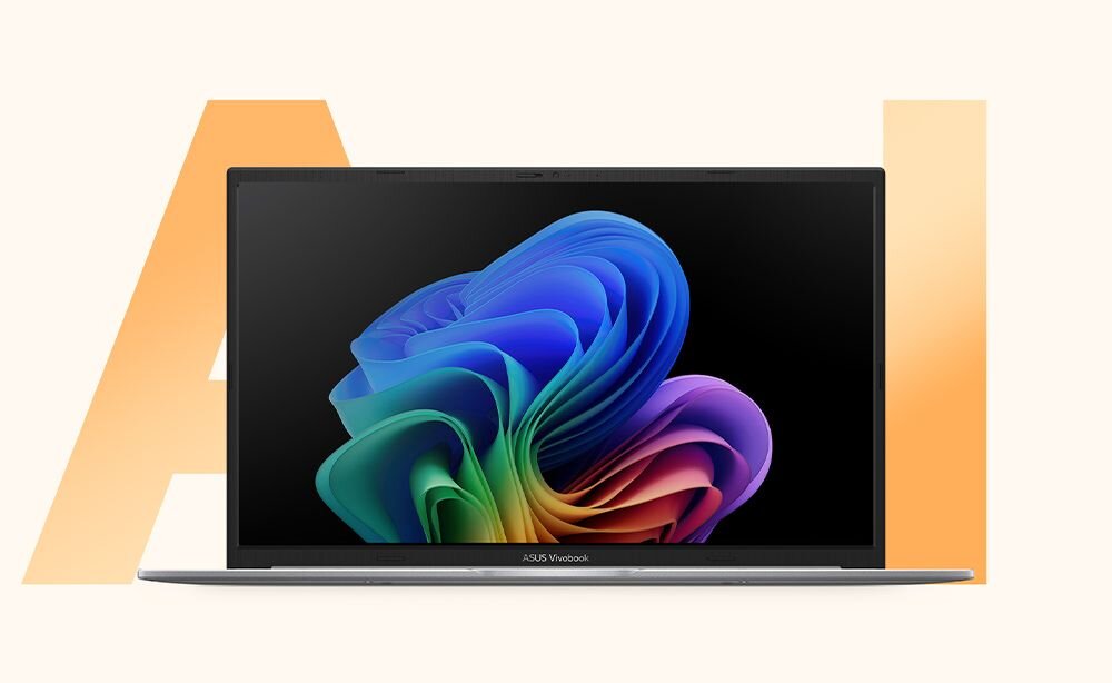 Laptop z wyświetlaczem pokazującym kolorową grafikę na ekranie. Na dolnej ramce ekranu widoczny jest napis \'ASUS Vivobook\'.