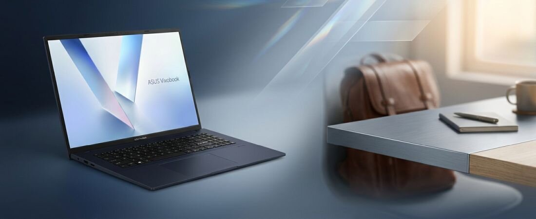 Na obrazie widoczny jest laptop z napisem \'ASUS Vivobook\' na ekranie, umieszczony na tle biurka z torbą i filiżanką. Scena jest oświetlona naturalnym światłem wpadającym przez okno.