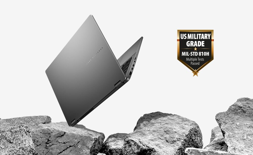 Laptop ASUS Vivobook 14 Flip TP3407SA-SG142W z certyfikatem MIL-STD-810H unosi się nad kamieniami, prezentując wytrzymałą obudowę w trudnym środowisku użytkowania