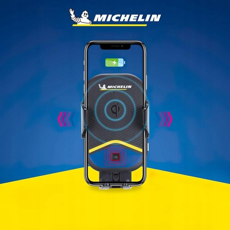 Obraz przedstawia uchwyt samochodowy na telefon z logo Michelin, z funkcją ładowania bezprzewodowego. Na ekranie telefonu widoczna jest ikona baterii z symbolem ładowania.
