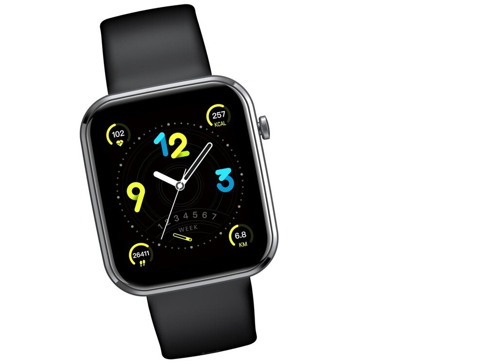 Smartwatch z czarnym paskiem i kolorowym wyświetlaczem, na którym widoczne są cyfry 9, 12 i 3 oraz dane: 102, 257 KCAL, 26411, 6.8 KM. Na tarczy zegarka znajduje się również napis \'WEEK\'.