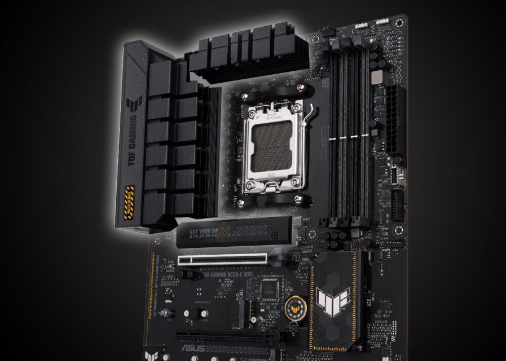 Płyta główna ASUS TUF Gaming B650-E WiFi ujęcie płyty z gniazdem procesora, radiatorami VRM i osłoną z logo serii, widoczne szczegóły laminatu