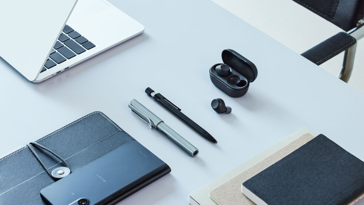 Słuchawki dokanałowe SONY WF-C710 ANC Wodoodporne na biurku obok notesu długipisa laptopa