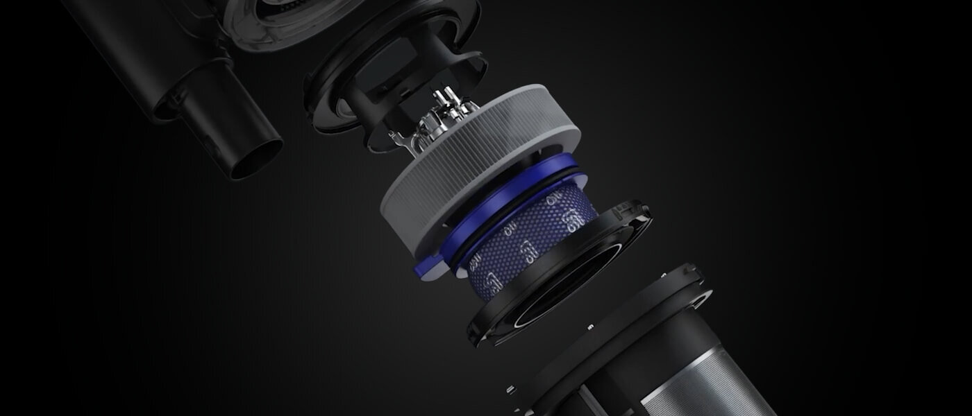 Obraz przedstawia rozłożony na części element odkurzacza, ukazujący szczegóły jego konstrukcji wewnętrznej. Widoczne są różne komponenty w odcieniach czerni, szarości i niebieskiego na ciemnym tle.