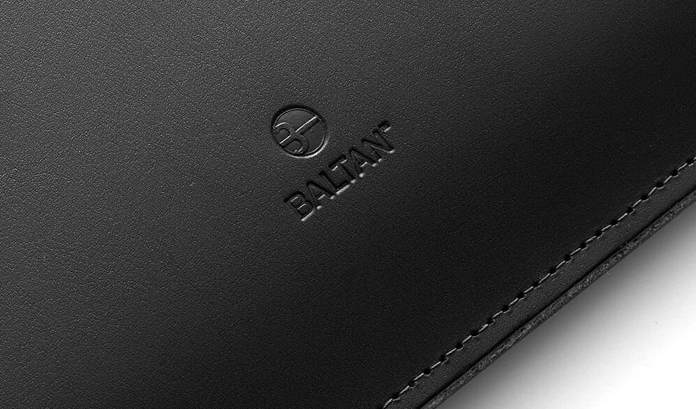 Czarne etui na laptopa z widocznym logo \'BALTAN\' wytłoczonym na powierzchni. Widoczne są również starannie wykonane szwy na krawędzi.