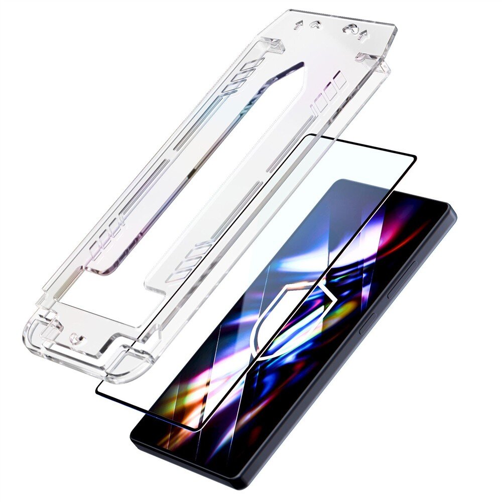 Obraz przedstawia szkło hartowane i ramkę montażową nad smartfonem z kolorowym wyświetlaczem. Szkło jest przezroczyste, a ramka ma wycięcia i otwory na krawędziach.