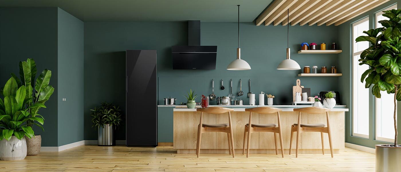 Ciemnozielone wnętrze kuchenne, do którego została wstawiona chłodziarka RR39C76C322 w kolorze głębokiej czerni z oferty Media Expert