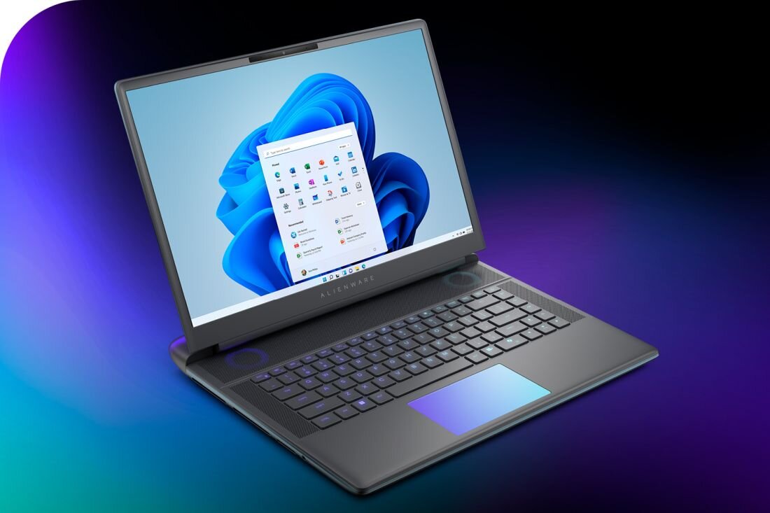  Otwarty laptop Alienware 16 Area-51 na gradientowym tle turkusowo-fioletowym, ekran z Windows 11 i niebieskim kwiatowym logo systemowym, okno aplikacji All Apps z kolorowymi ikonami, grafitowa klawiatura z niebiesko-fioletowym touchpadem podświetlanym po prawej, czarne ramki ekranu z logo Alienware, smukła premium konstrukcja dla profesjonalistów - System Windows 11 