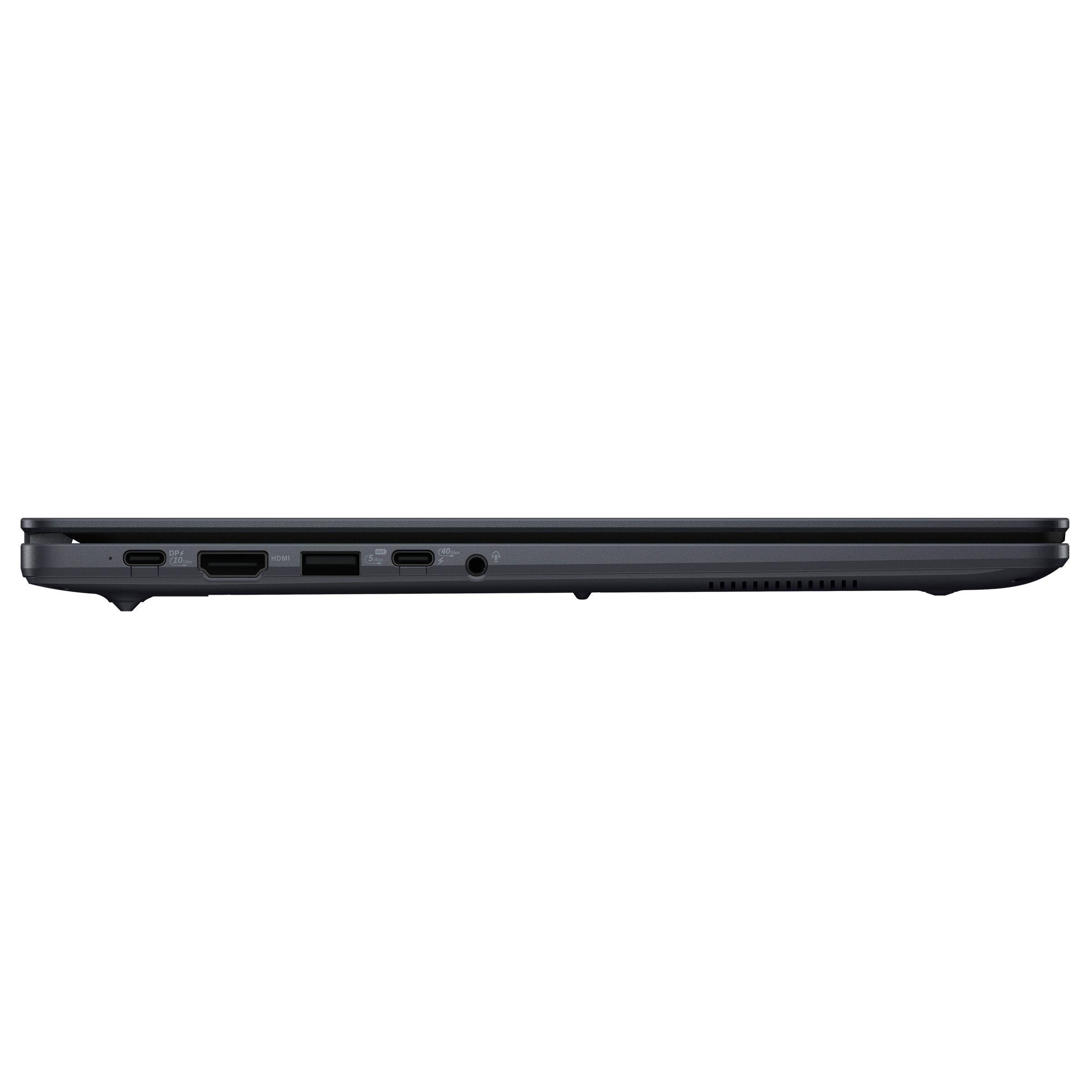 Widok boczny laptopa z zamkniętą pokrywą, ukazujący różne porty, w tym HDMI, USB i gniazdo audio. Obudowa jest w kolorze ciemnoszarym.