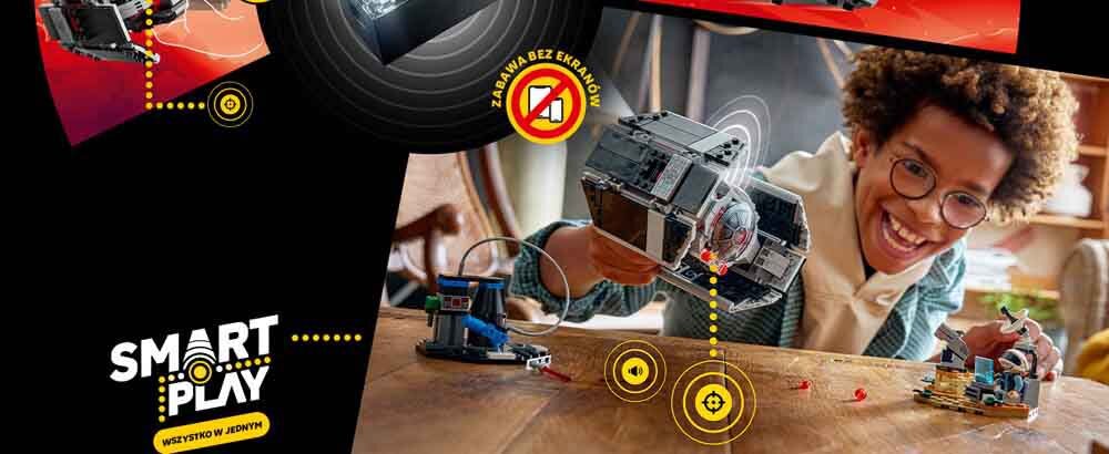 Osoba bawi się modelem myśliwca TIE z serii LEGO Star Wars na drewnianym stole. Widoczne są napisy: \'SMART PLAY\', \'WSZYSTKO W JEDNYM\' oraz \'ZABAWA BEZ EKRANÓW\'.