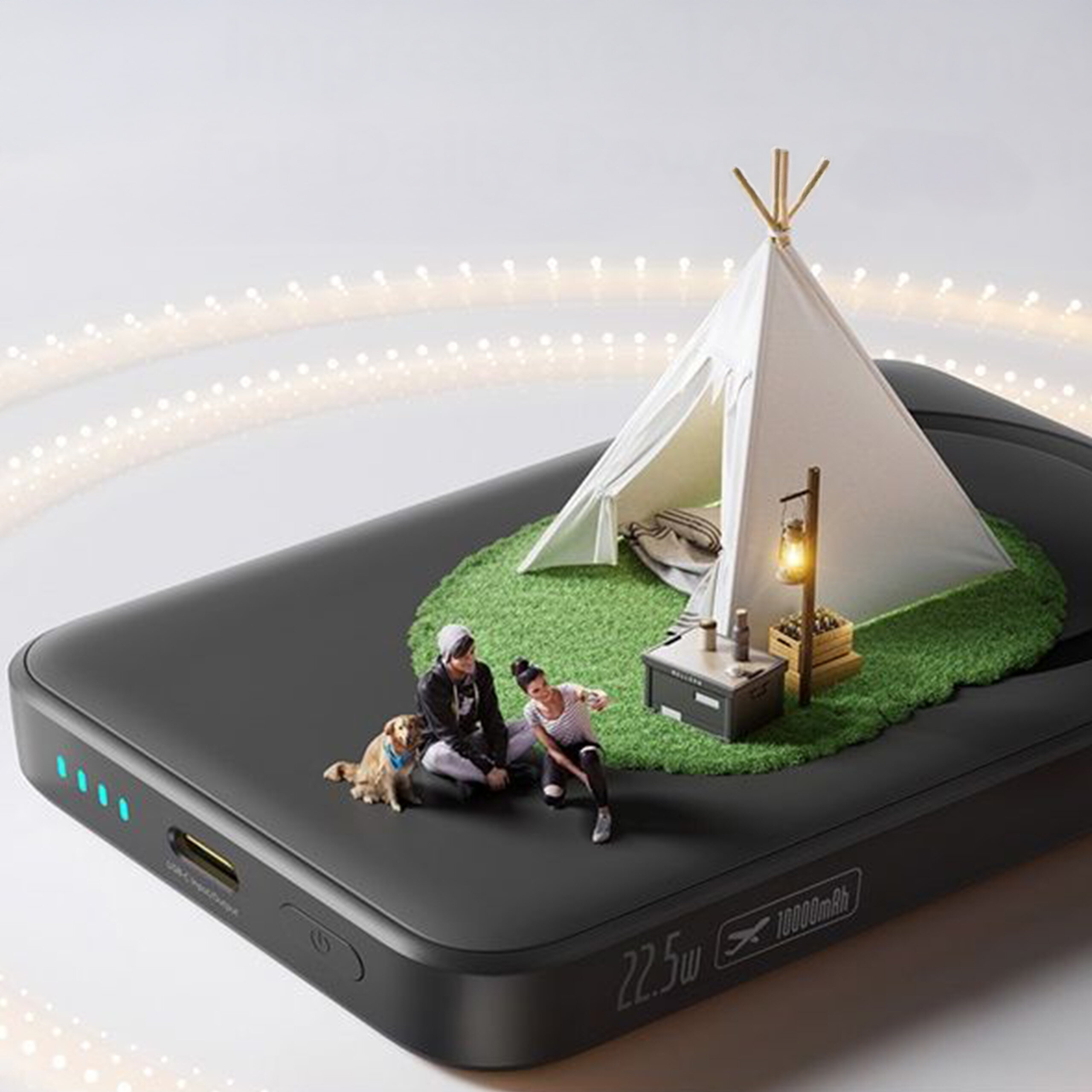 Na czarnym power banku znajduje się miniaturowa scena z namiotem, dwiema osobami i psem na trawie. Na urządzeniu widoczny jest napis \'22.5w\' oraz \'10000mAh\'.