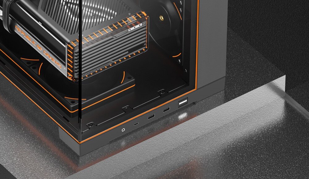 Obudowa THERMALRIGHT A70 ARGB Fan Zbliżenie na dolny przedni róg złożonej obudowy pokazujące zewnętrzny panel z gniazdem audio i portami USB, przez szybę widać fragment karty graficznej z napisem 'REPUBLIC OF GAMERS' oraz podświetlane na pomarańczowo wentylatory