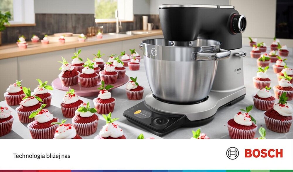 Na blacie kuchennym stoi robot kuchenny z dużą metalową misą, otoczony przez wiele babeczek z białym kremem i zielonymi listkami. Na dole obrazu widnieje napis \'Technologia bliżej nas\' oraz logo BOSCH.