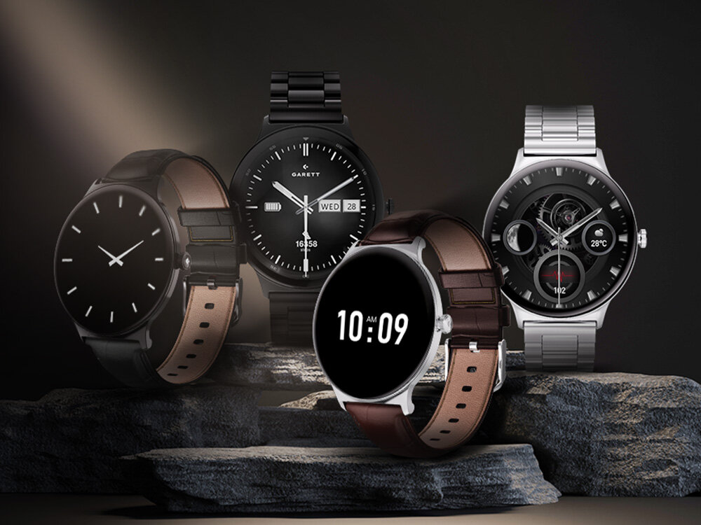 Na obrazie widoczne są cztery smartwatche o różnych wzorach tarcz i paskach, ustawione na kamiennym tle. Jeden z zegarków ma wyświetlony czas \'10:09\', a na innym widnieje logo \'GARETT\'.