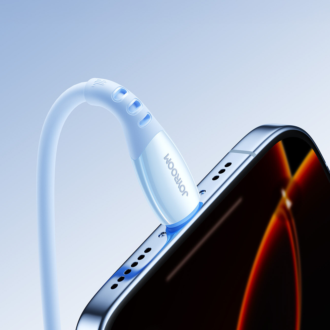 Niebieski kabel z logo \'JOYROOM\' jest podłączony do urządzenia z ekranem. Kabel ma zaokrągloną końcówkę z trzema widocznymi wypustkami.