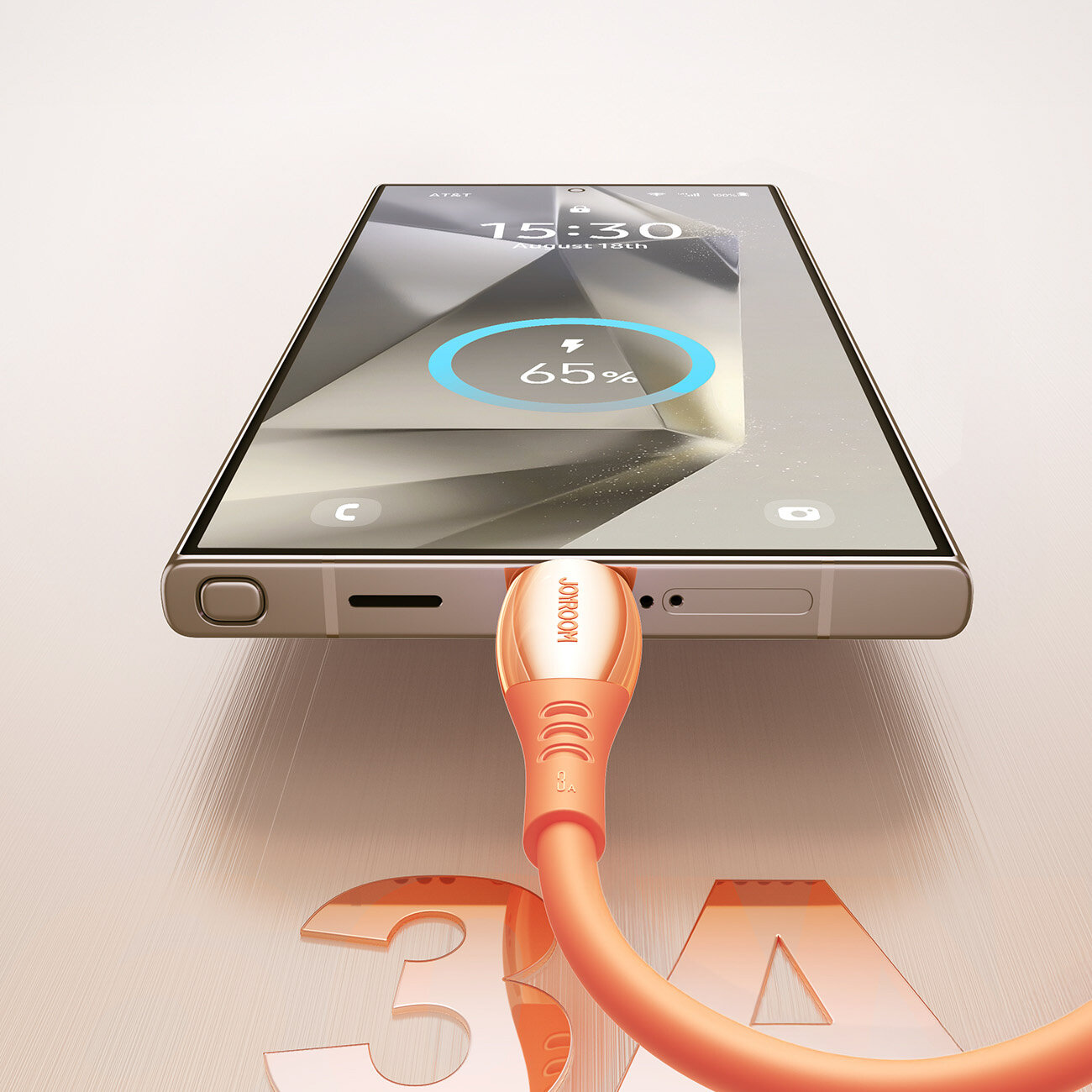 Smartfon z podłączonym pomarańczowym kablem USB-C, na ekranie widoczny jest wskaźnik ładowania na poziomie 65%. Na kablu znajduje się napis \'JOYROOM\', a na powierzchni obok widoczny jest duży napis \'3A\'.