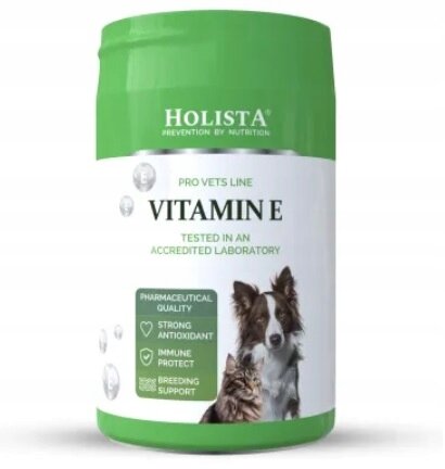 Opakowanie produktu Holista Vitamin E z zieloną pokrywką i białą etykietą, na której widnieje napis \'PRO VETS LINE VITAMIN E TESTED IN AN ACCREDITED LABORATORY\'. Na etykiecie znajdują się również zdjęcia psa i kota oraz informacje o jakości farmaceutycznej, działaniu antyoksydacyjnym, ochronie immunologicznej i wsparciu hodowli.