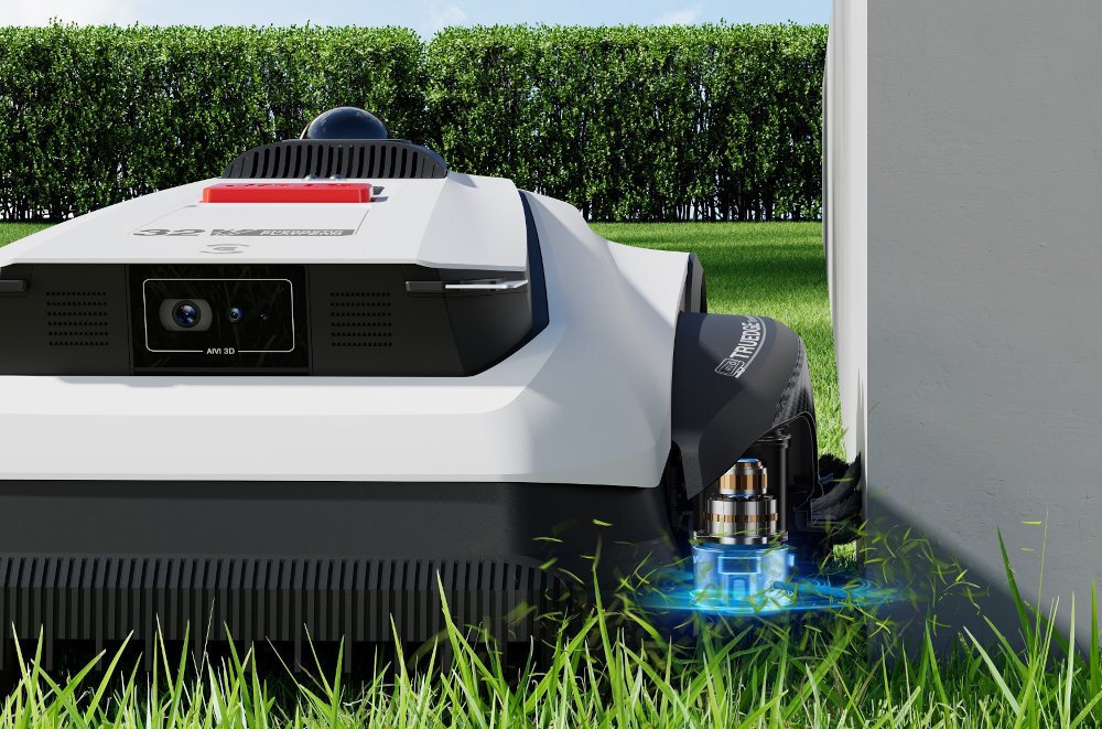 Robot koszący o nowoczesnym designie porusza się wzdłuż ściany na tle zielonego trawnika i żywopłotu. Na urządzeniu widoczne są napisy \'AI Vision\' oraz \'media expert\'.