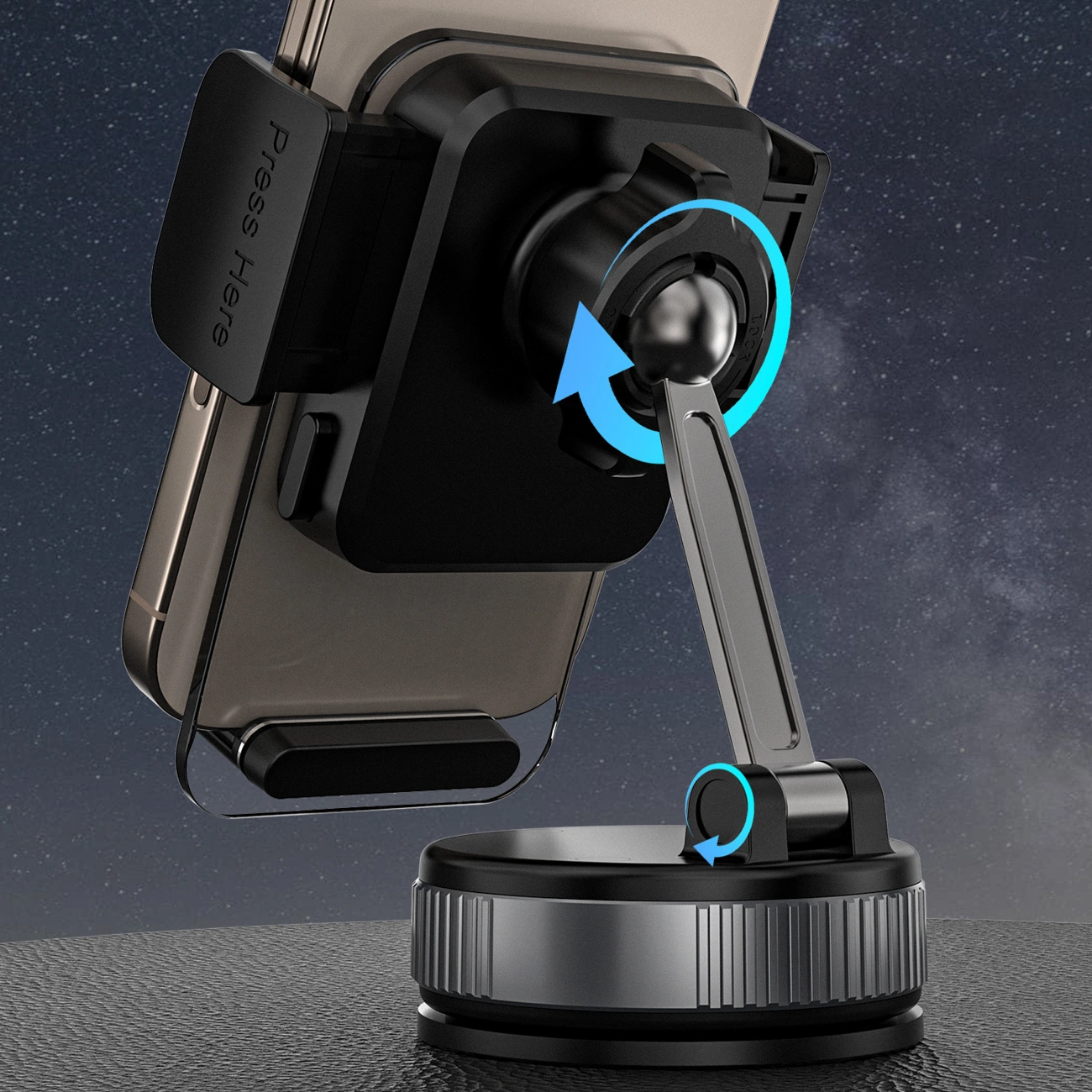 Czarny uchwyt samochodowy z przyssawką, trzymający smartfon, z widocznym napisem \'Press Here\'. Uchwyt posiada mechanizm obrotowy, wskazany niebieskimi strzałkami.
