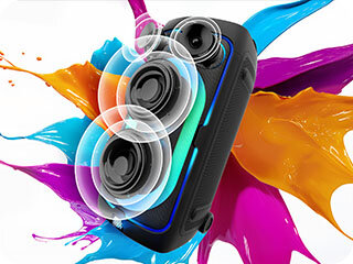 Sound Tower against paint color splash background plays powerful sound, as shown by soundwaves coming from the speaker cones.