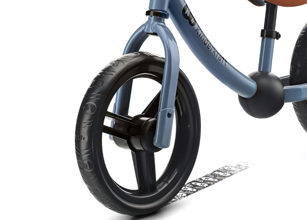 Rowerek biegowy 2WAY NEXT 2022 BLUE białe tło zbliżenie na czarne koło niebieska obudowa ślad pod kołem koła wykonane z pianki bez śladów na podłodze do użytkowania w domu funkcja blokady skrętu kierownicy tylne koło z łożyskami płynność jazdy wzmacnia trwałość całej konstrukcji 