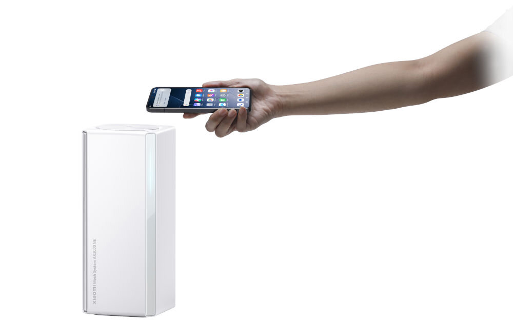 Router XIAOMI Mesh System AX3000 NE 2.4 / 5 GHz (DualBand), Wi-Fi Mesh (1 szt.) prezentacja działania NFC ręka z telefonem zbliżającym się do routera na białym tle NFC natychmiastowe połączenie ze smartfonem ułatwienie korzystania z sieci