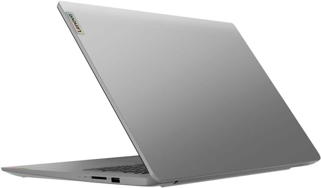 Laptop w kolorze srebrnym z widocznym logo Lenovo na pokrywie. Urządzenie jest częściowo otwarte, ukazując klawiaturę i porty po jednej stronie.